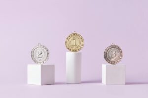 Medals on Pedestal on Pink Studio Background